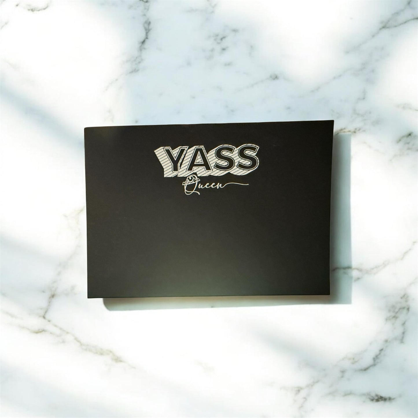 Black notecard with "YASS Queen" white embossed text, personalized custom stationery on marble surface. - “YASS Queen” Black Notecard