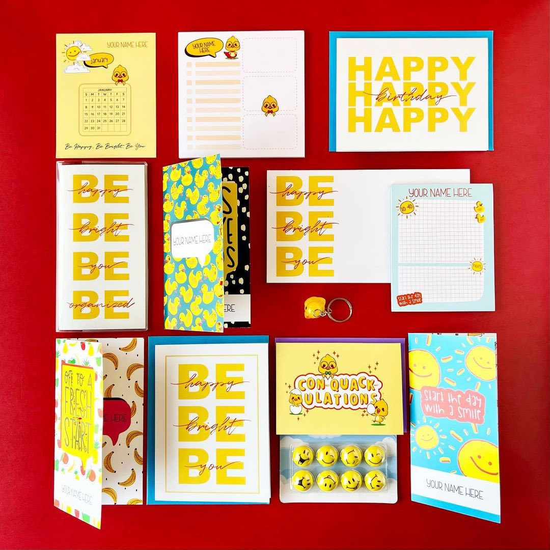 Collection of colorful stationery items on a red background