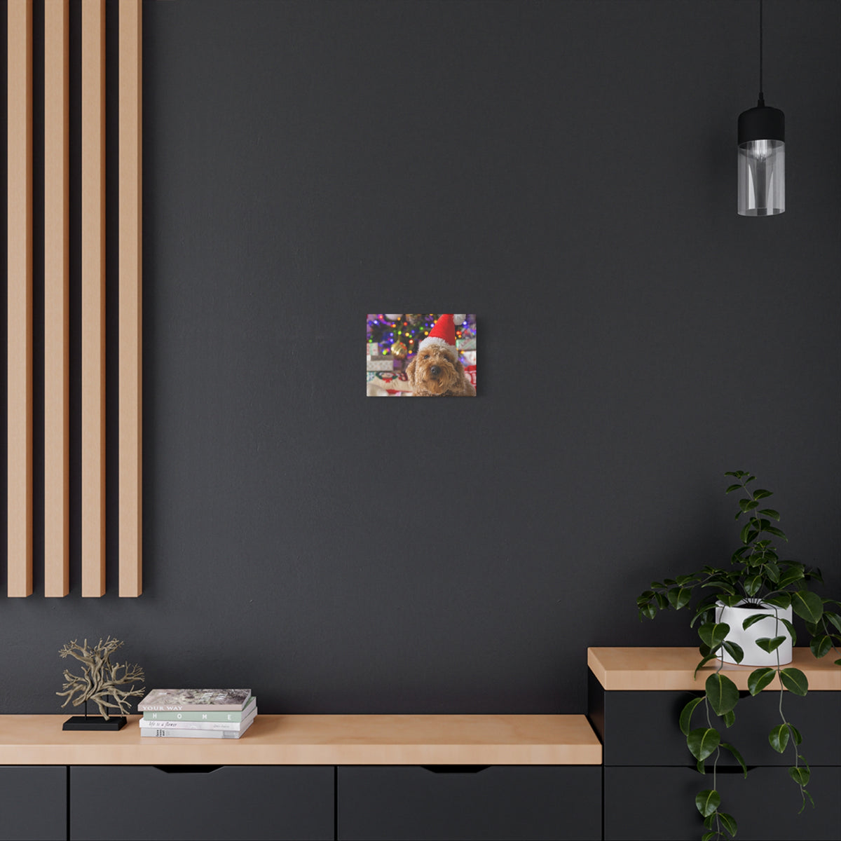 Small personalized photo canvas print featuring a cute dog with holiday decorations on a dark gray wall above a wooden bench .