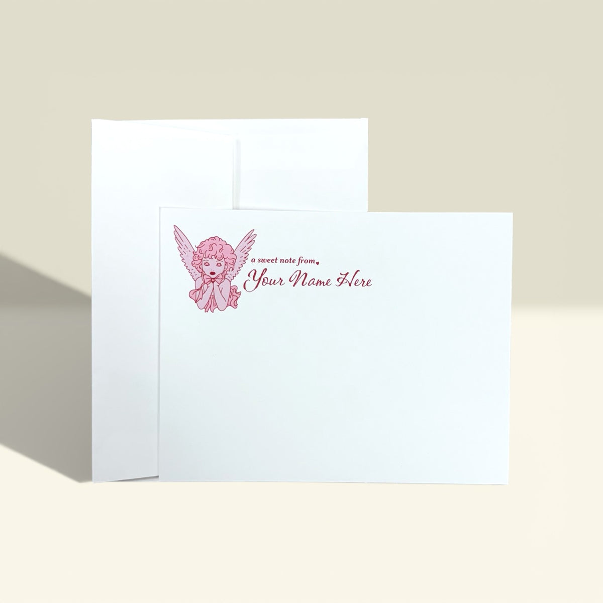 Set of white personalized note cards with pink angel graphic and "From the desk of Your Name Here" text.