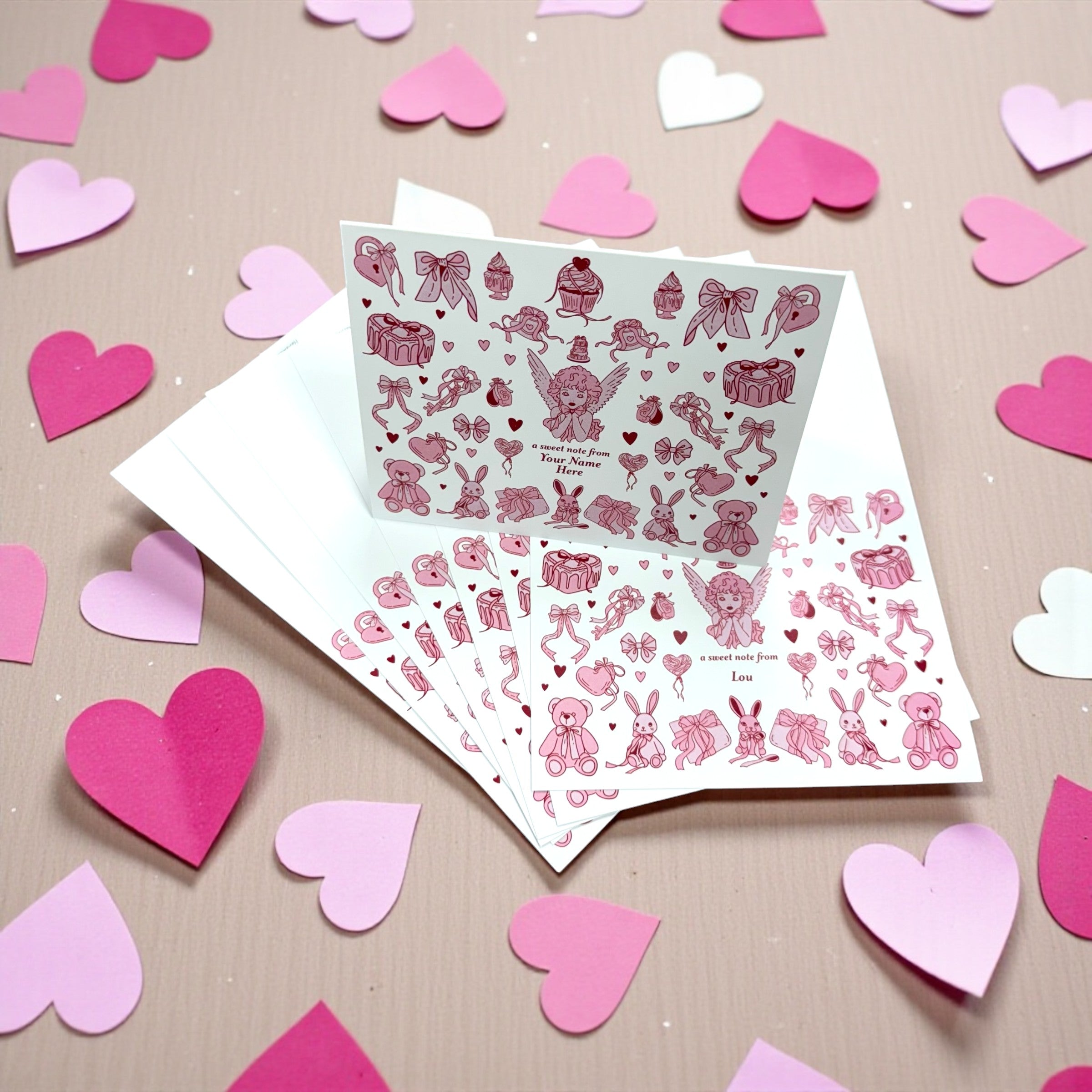 Set of 10 note cards with pink and purple angel-themed collage designs on white paper surrounded by pink heart cutouts.
