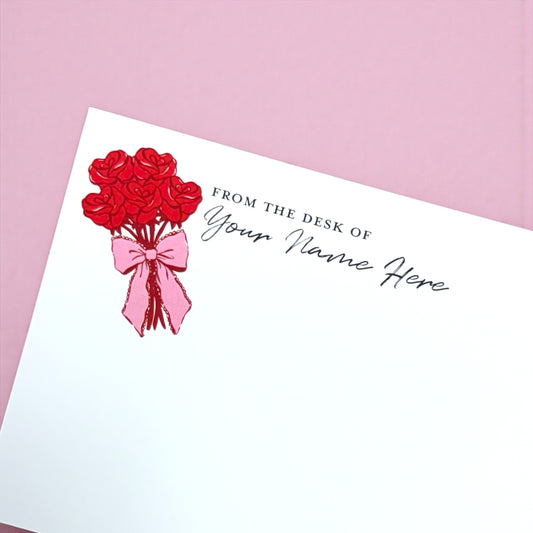 Notepad with red rose bouquet illustration and customizable "From the desk of Your Name Here" text on white paper.