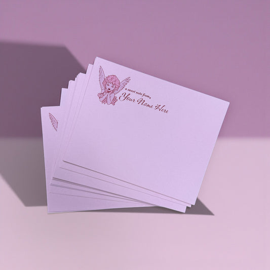 Set of pink notecards with a small angel illustration and personalized text in corner.