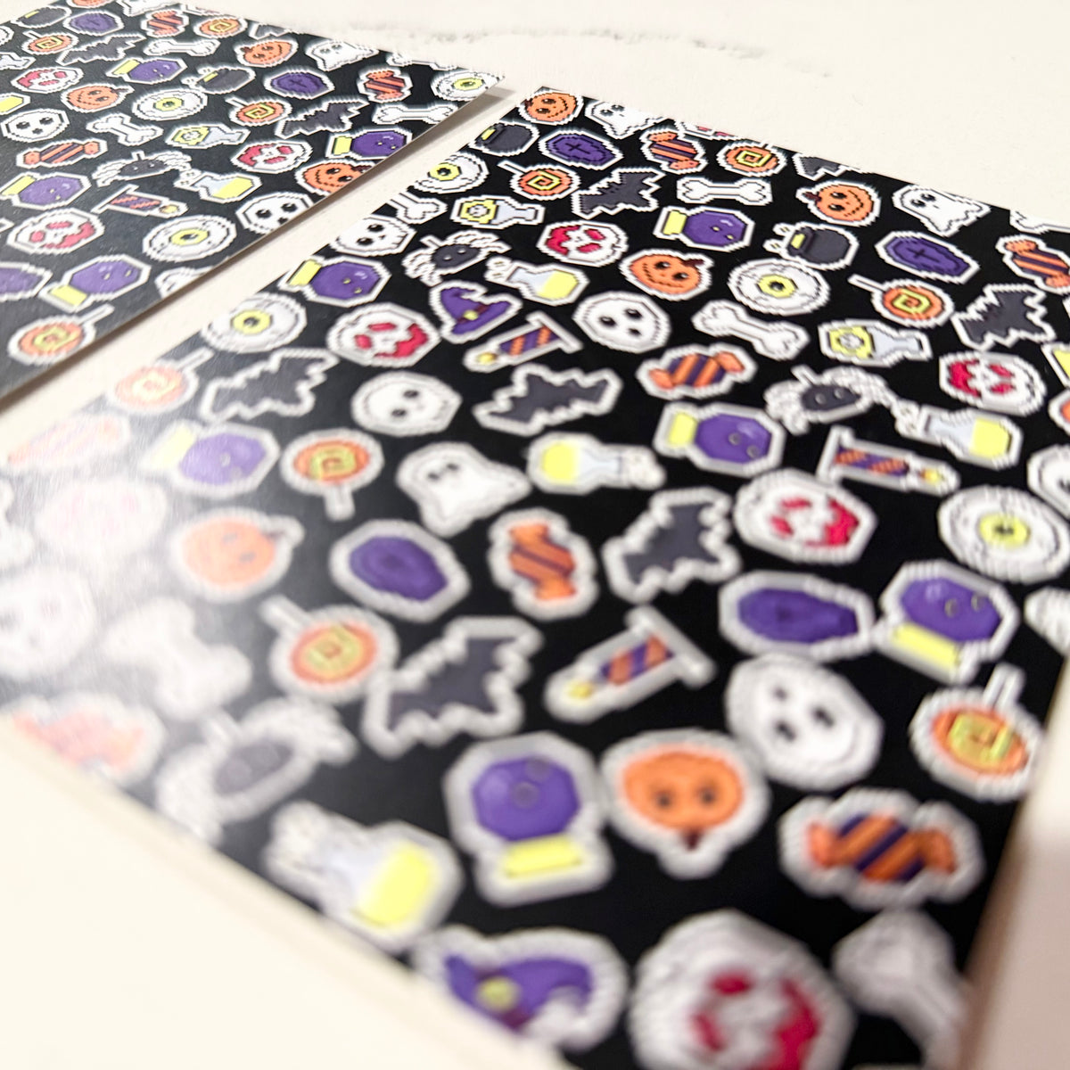 Halloween-themed stationery notecards with custom pixel art featuring ghosts, pumpkins, skulls, and candy on a black. - Halloween Pixels Notecard Set