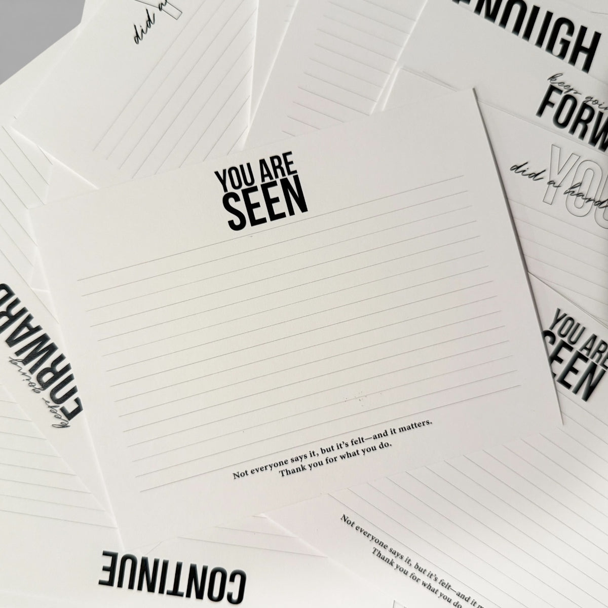 Stack of white personalized stationery notecards with black "You Are Seen" text and subtle lined design. - Quiet moments Notecard Set