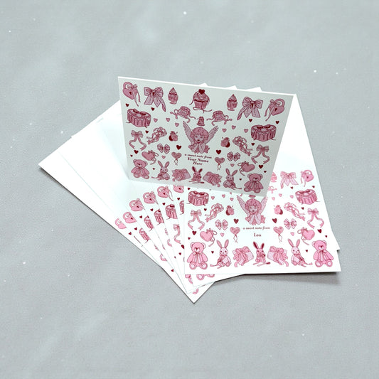 Set of 10 note cards with pink angel and heart collage design on white background, includes envelopes.
