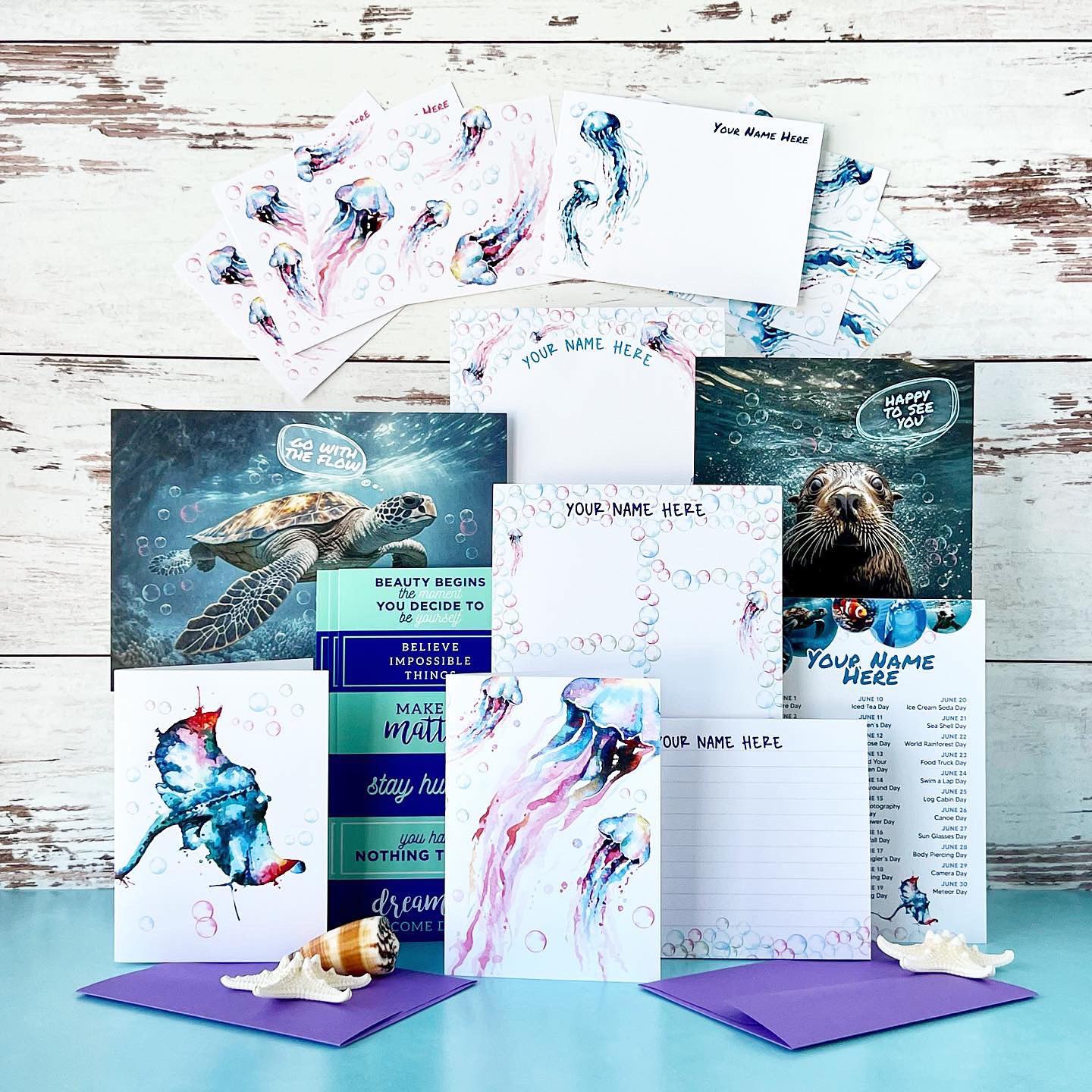 Personalized notepads featuring watercolor jellyfish and bubble bordersFlat notecards decorated with flowing jellyfish art and your personalizationOcean-themed greeting cards including designs like “Go With the Flow” and “Happy to Sea You”Sticker sheets filled with jellyfish illustrations and matching bubble elementsInspirational art prints with ocean quotes and calming color palettesA monthly calendar card with sea-life artworkSmall beachy extras like shells and coastal accents to complete the vibe