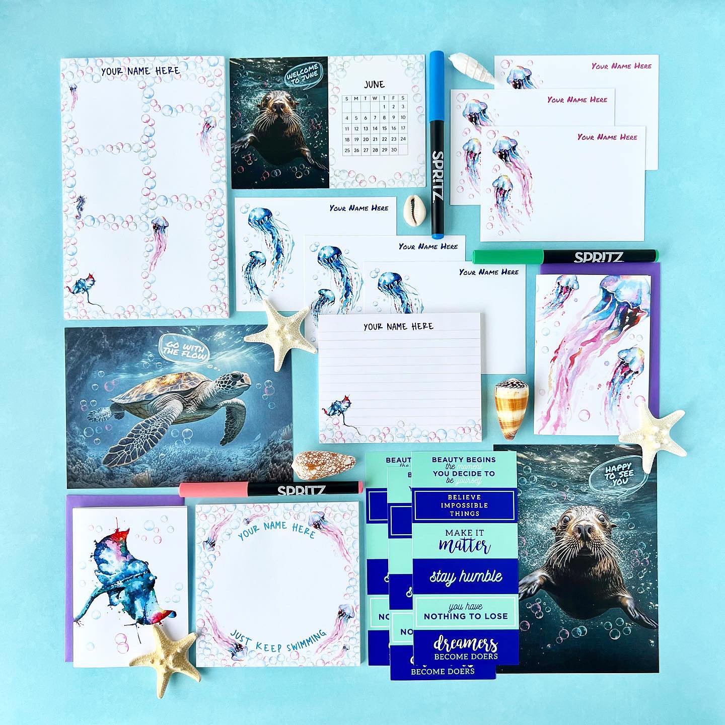 Collection of stationery items including cards, a calendar, and stickers on a blue background
