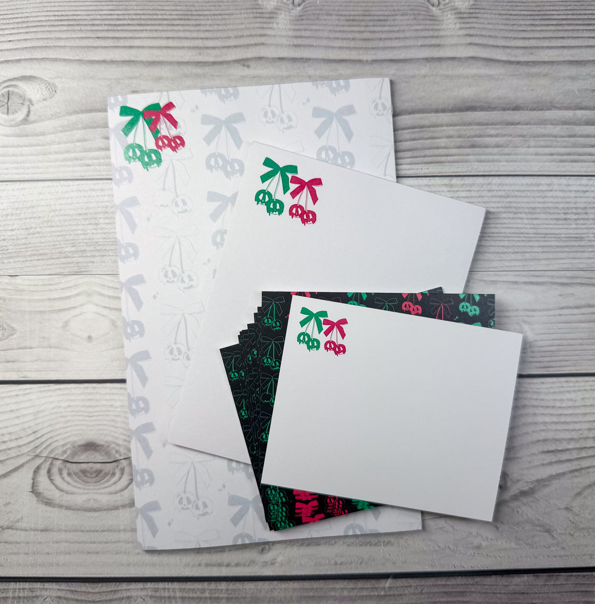 Custom personalized stationery set featuring a notepad and two notecards with red and green cherry designs. - Scary Cherries Notepad and Notecard set