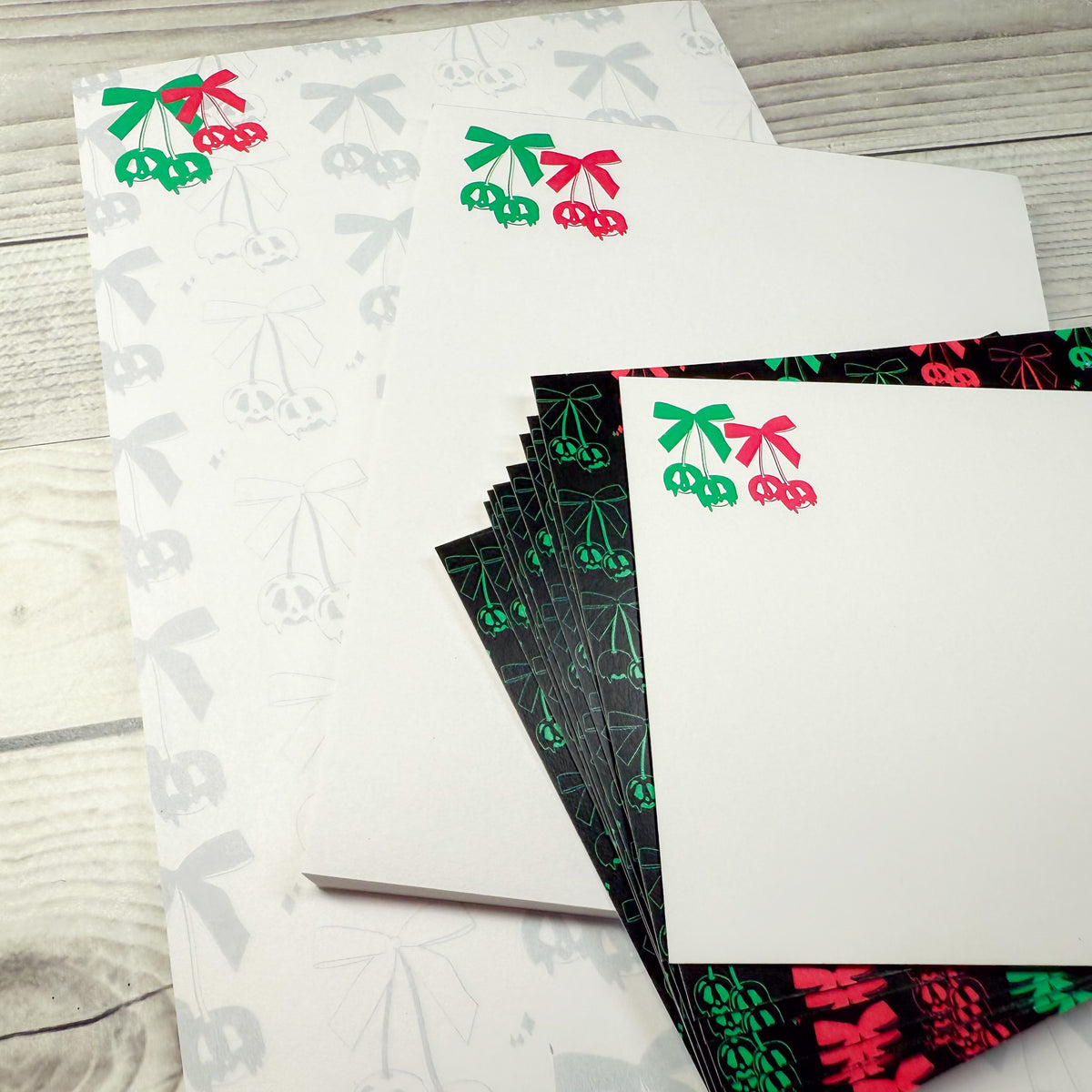 Custom personalized stationery set featuring notepads and notecards with red and green cherry design on white and black. - Scary Cherries Notepad and Notecard set