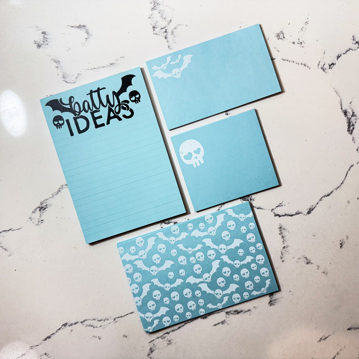 Blue stationery set with custom skull designs, personalized notepad, and matching notecards. - Special Edition Skull Stationery Gift Set | Cute Goth Notecards & Notepad