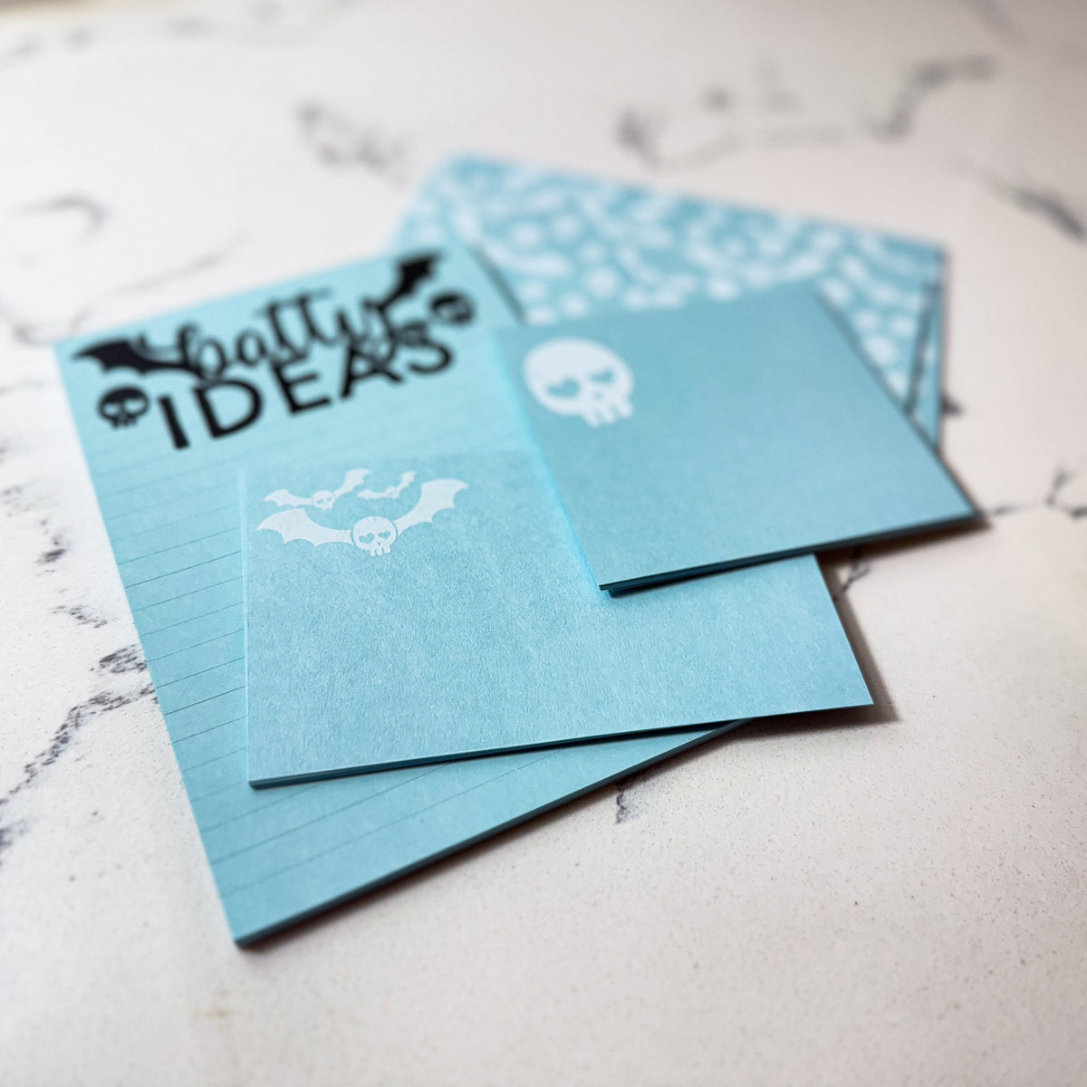 Blue custom stationery set featuring goth skull designs and "batty ideas" notepad with personalized style. - Special Edition Skull Stationery Gift Set | Cute Goth Notecards & Notepad