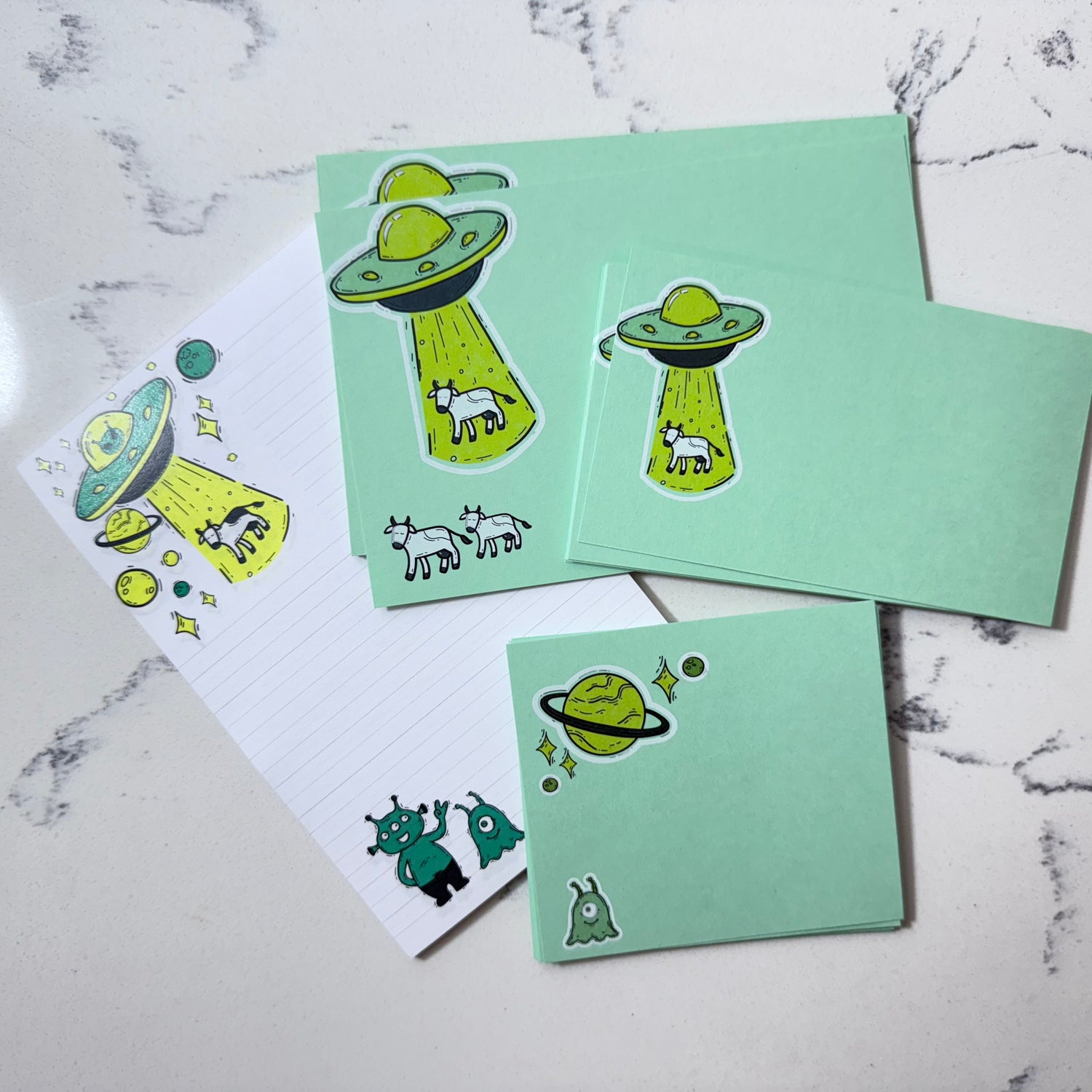 Custom stationery gift set with cute UFO notecards, personalized notes, and alien designs in green shades. - Alien Abduction Stationery Gift Set | Cute UFO Notecards & Notepad