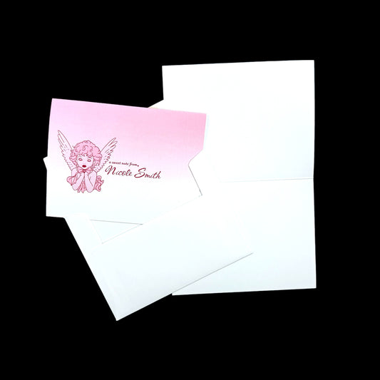 Folded A2 note card with pink angel illustration and personalized name on white paper with matching envelope.