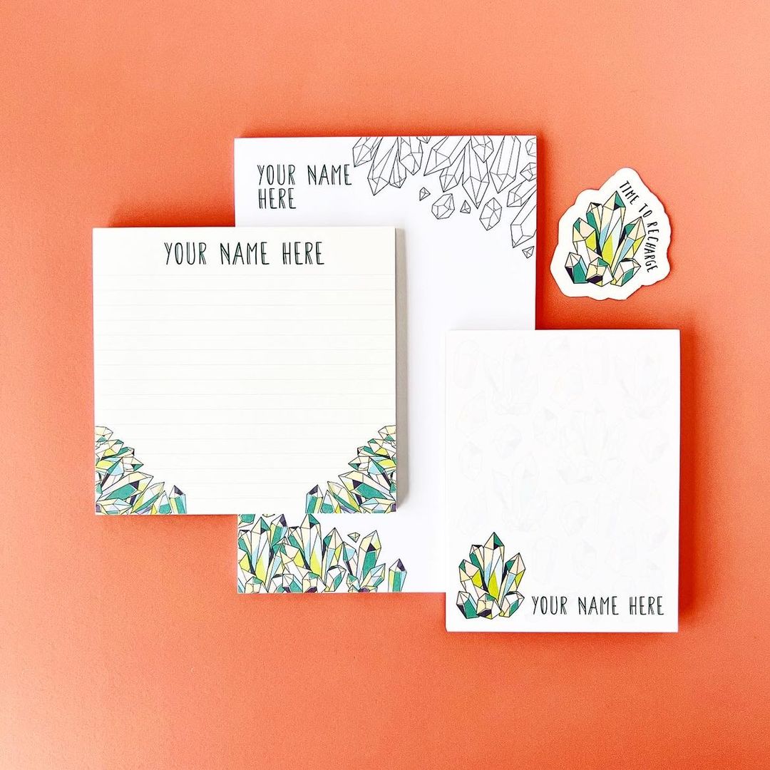 Note cards and a sticker with crystal designs on an orange background