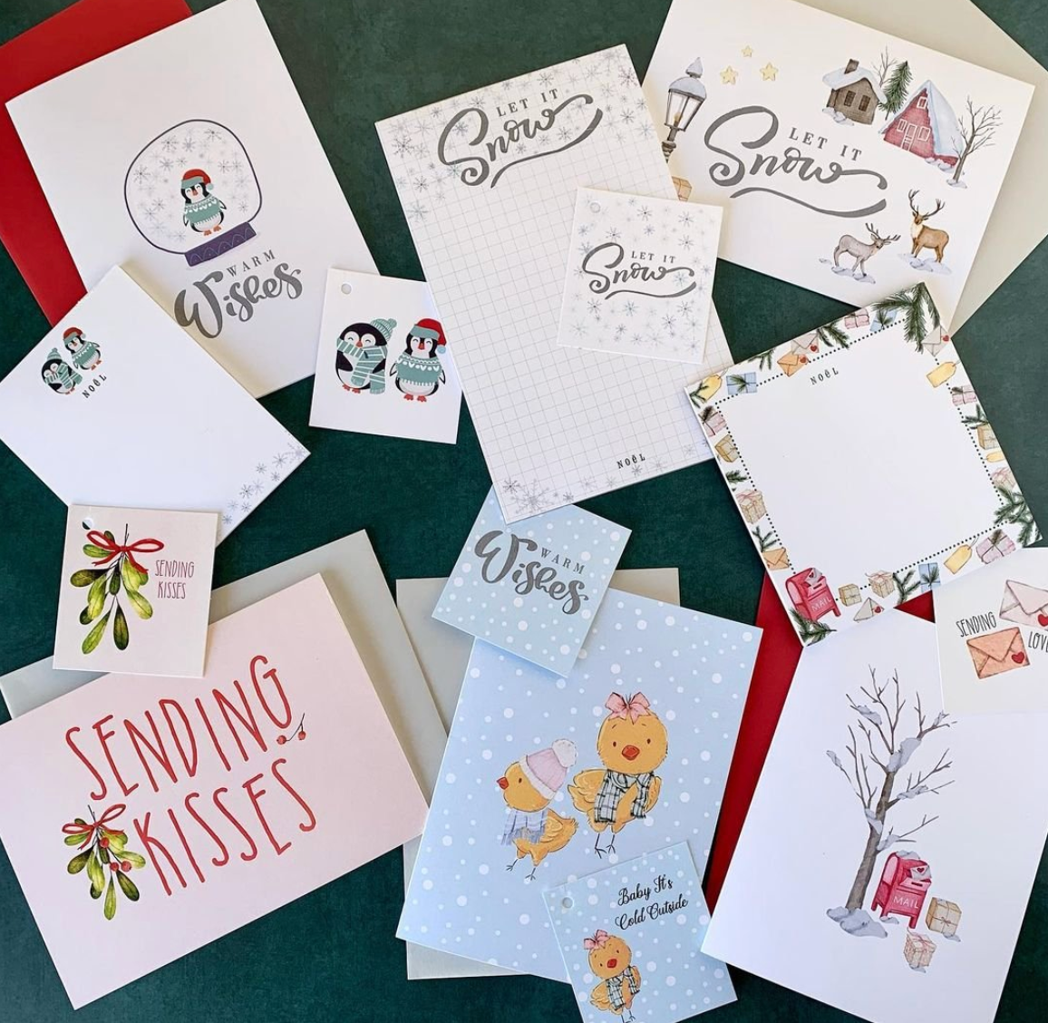 Collection of Christmas-themed greeting cards on a green surface