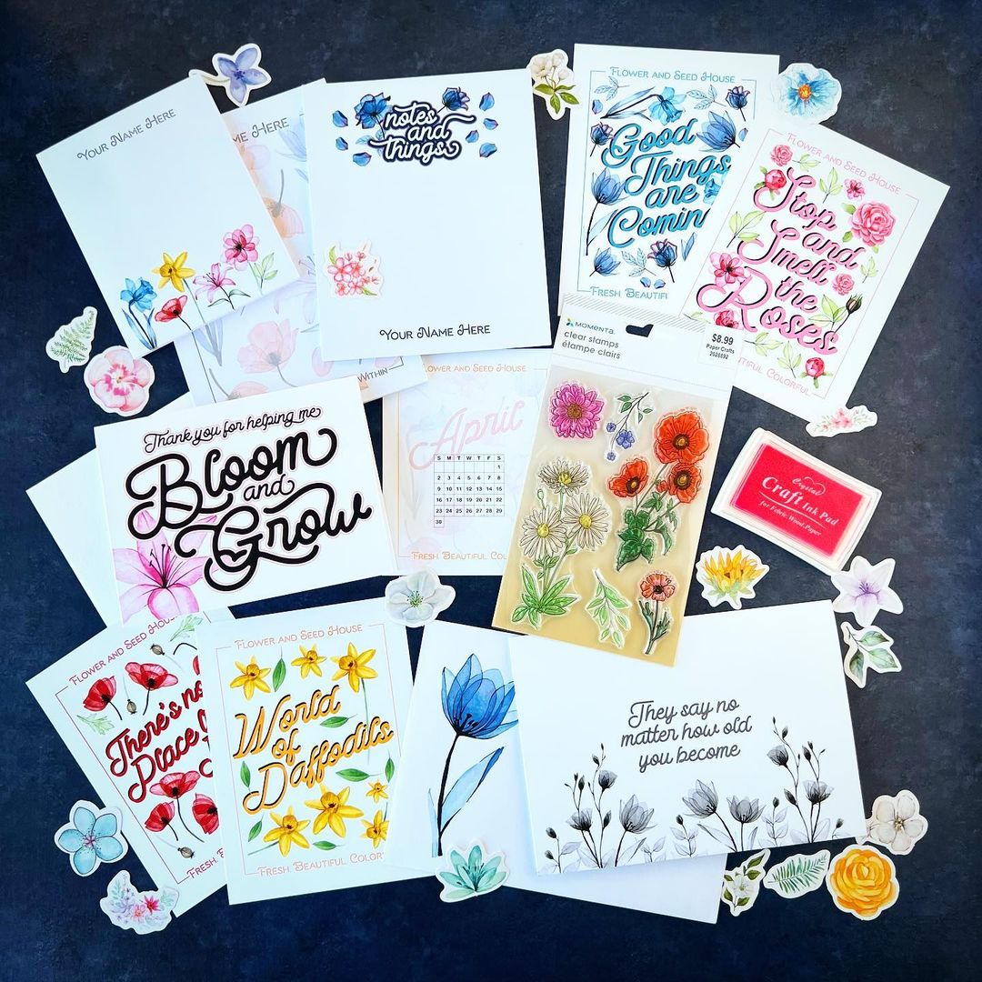 Collection of floral and motivational cards on a dark surface
