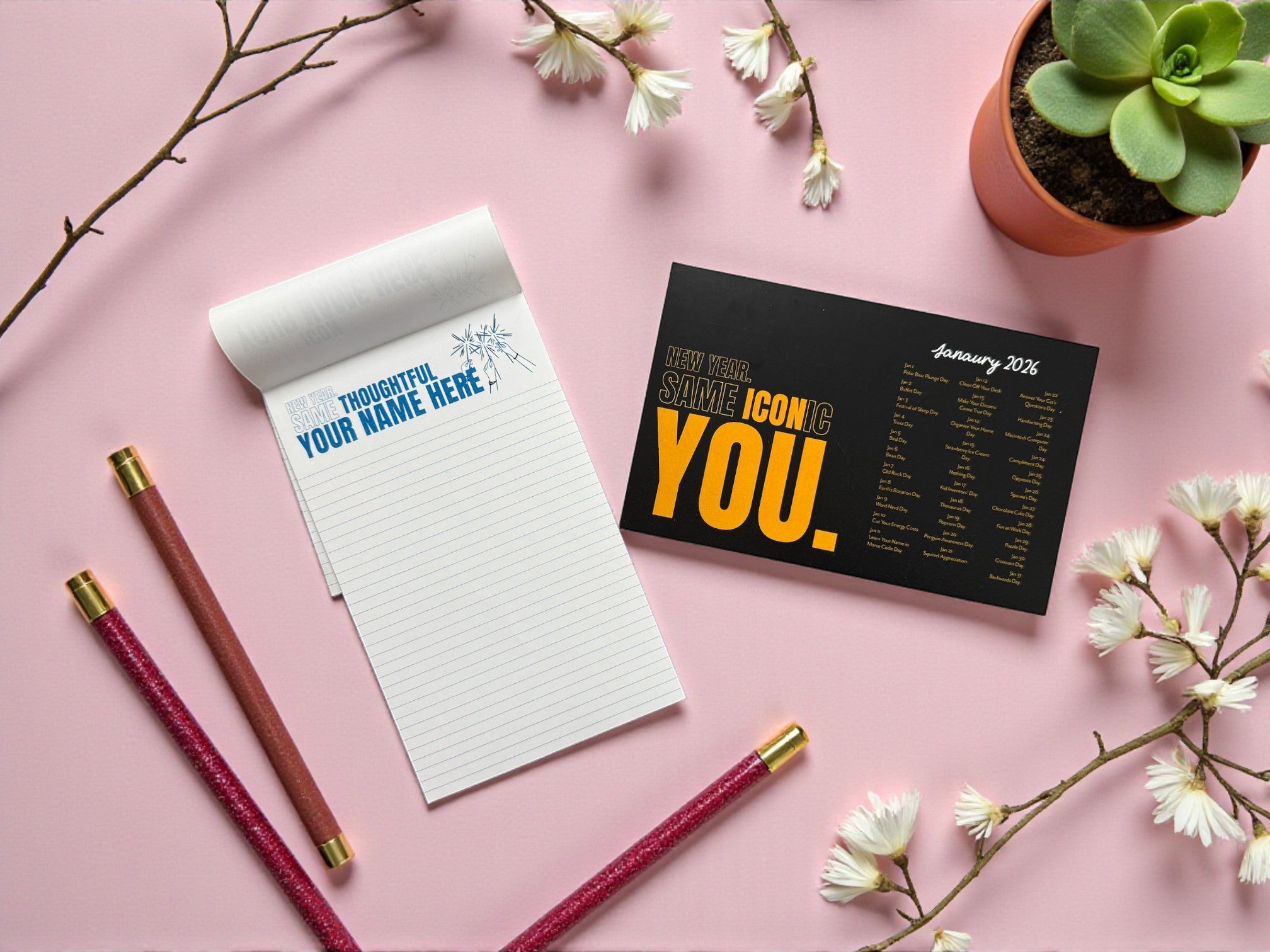 Notepad, pen, and decorative items on a pink surface with flowers and a plant.