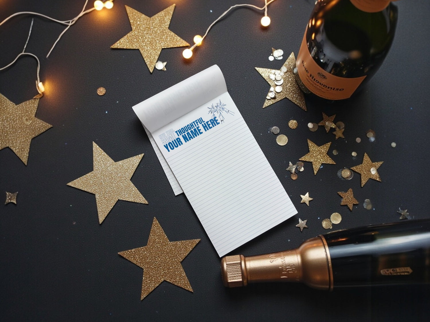 Notebook with a personalized message surrounded by decorative stars and a bottle on a dark surface.