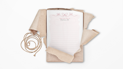Notebook with beige ribbon on a white background
